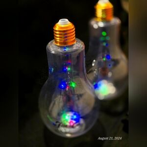 Fun party plastic light bulb flasks by Ron Flor de Cana. Replaceable batteries!